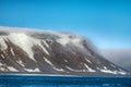 Cloud caught on the glacial sheet, nunatak in fog