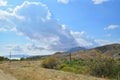 The cloud comes up from behind the mountains in the Karadag National nature reserve Royalty Free Stock Photo