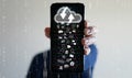 Cloud Computing Concept.A man uses a smartphone to upload and download IT resources via cloud technology Royalty Free Stock Photo