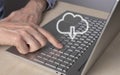 Cloud computing. Man using laptop for download files from remote database. Forefinger closeup pressing on enter button