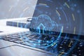 Cloud computing technology and data storage concept with digital graphic glowing blue cloud symbol with arrow up on laptop