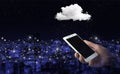 Cloud computing technology internet concept background. Hand hold white smartphone with digital hologram cloud sign on city dark Royalty Free Stock Photo