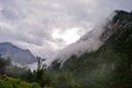A cloud covering a mountain in the High Alps