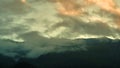 cloud formation on top mountain, wind turbine in the fog on mountain ridge Royalty Free Stock Photo