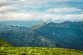 Cloud layers on mountain horizon with green grass Royalty Free Stock Photo