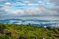 Cloud layers on mountain horizon with green grass Royalty Free Stock Photo