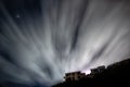 Cloud movement in the night sky over two empty buildings