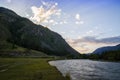 Cloud over the mountain range. Blue sky and green grass in the valley of a mountain river Royalty Free Stock Photo