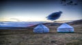 Cloud over the yurts at the shore of Song Kol Lake at the dawn, Kyrgyzstan
