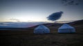 Cloud over the yurts at the shore of Song Kol Lake at the dawn, Kyrgyzstan