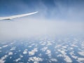 Cloud patterns with airplane flying between layers Royalty Free Stock Photo