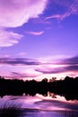 Cloud purple dramatic sunset sky reflection on water lake scenery nature background Royalty Free Stock Photo