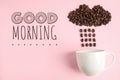 Cloud and raindrops made of coffee beans falling into cup on pink background, flat lay. Good morning Royalty Free Stock Photo