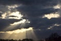 Cloud rays, sun harps or bucket ladders, twilight rays or crepuscular rays over the city Zoetermeer