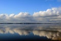 Cloud reflection in the river. Light skies, clouds.