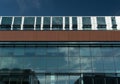 Cloud reflections in tall glass walls of an office building Royalty Free Stock Photo