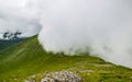 Cloud rolling over mountain ridge in Scottish Highlands. Royalty Free Stock Photo