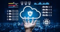 Cloud Security Concept with Hand Reaching for Cloud Files and Data Protection Icons against Blurred Cityscape at Night Royalty Free Stock Photo