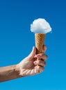 Cloud in shape of ice cream as if it placed in the cone of ice cream. Creative summer concept