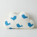 Cloud-shaped plush pillow featuring a pattern of blue bird illustrations. The pillow is Royalty Free Stock Photo