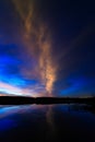 Cloud in the sky lit morning dawn, reflected in the water Royalty Free Stock Photo