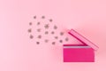 Cloud of snowflakes bursting out of open pink giftbox. Royalty Free Stock Photo