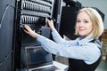 Cloud storage service. female engineer replacing hard drive in server Royalty Free Stock Photo