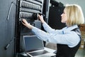 Cloud storage service. female engineer replacing hard drive in server Royalty Free Stock Photo