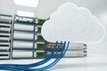 Cloud storage symbol linked to server rack with blue network cables Royalty Free Stock Photo