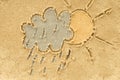 Cloud and sun drawing in sand Royalty Free Stock Photo