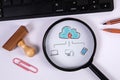 Cloud technology concept. Magnifying glass and computer keyboard on office table Royalty Free Stock Photo