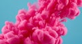 Cloud of vibrant pink ink dispersing in water against a light blue background. The ink Royalty Free Stock Photo