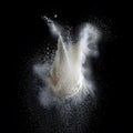 A cloud of white powder exploding against a black background Royalty Free Stock Photo