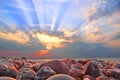 Cloudburst sun rays at sunset on whitstable beach Royalty Free Stock Photo