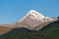 Gergeti Glacier - A cloudless view on Mount Kazbeg in Caucasus, Georgia. There slopes are barren and stony Royalty Free Stock Photo