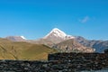 Gergeti Glacier - A cloudless view on Mount Kazbeg in Caucasus, Georgia. There slopes are barren and stony Royalty Free Stock Photo