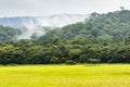 Clouds above a forested hill