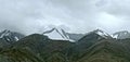 Clouds above mountains covered with snow Royalty Free Stock Photo