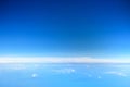 Clouds against blue sky view through an airplane window for a background Royalty Free Stock Photo