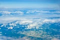 Clouds against blue sky view through an airplane window for a background Royalty Free Stock Photo