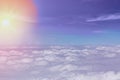 Clouds background with blue sky and sun during sunrise from above. View from airplane window Royalty Free Stock Photo