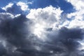 Clouds in black grey white colors in blue sky leaving region after a rainy weather period on a spring summer day and bright sun Royalty Free Stock Photo