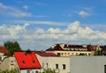 Clouds in the blue sky above the roofs of multi-family houses. Summer. Day Royalty Free Stock Photo