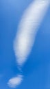 Clouds in the blue sky in the form of an exclamation mark. Summer weather