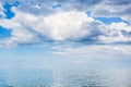 Clouds in blue sky over calm water of Azov Sea