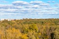 clouds in blue sky over colorful forest and city Royalty Free Stock Photo