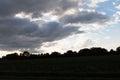 Clouds and blue sky over a grass area and trees at the horizon in geeste emsland germany Royalty Free Stock Photo