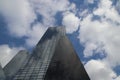 Clouds and blue sky reflecting in the mirror windows of skyscrater Delftse Poort in Rotterdam in the Netherlands