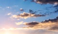 Clouds on the blue sky. Sunset. The sun`s rays shine on the clouds. Heaven`s heaven. Paradise. Peace and tranquility Royalty Free Stock Photo