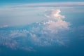 Clouds and blue sky view out from window of airplane flying over earth ground. Royalty Free Stock Photo